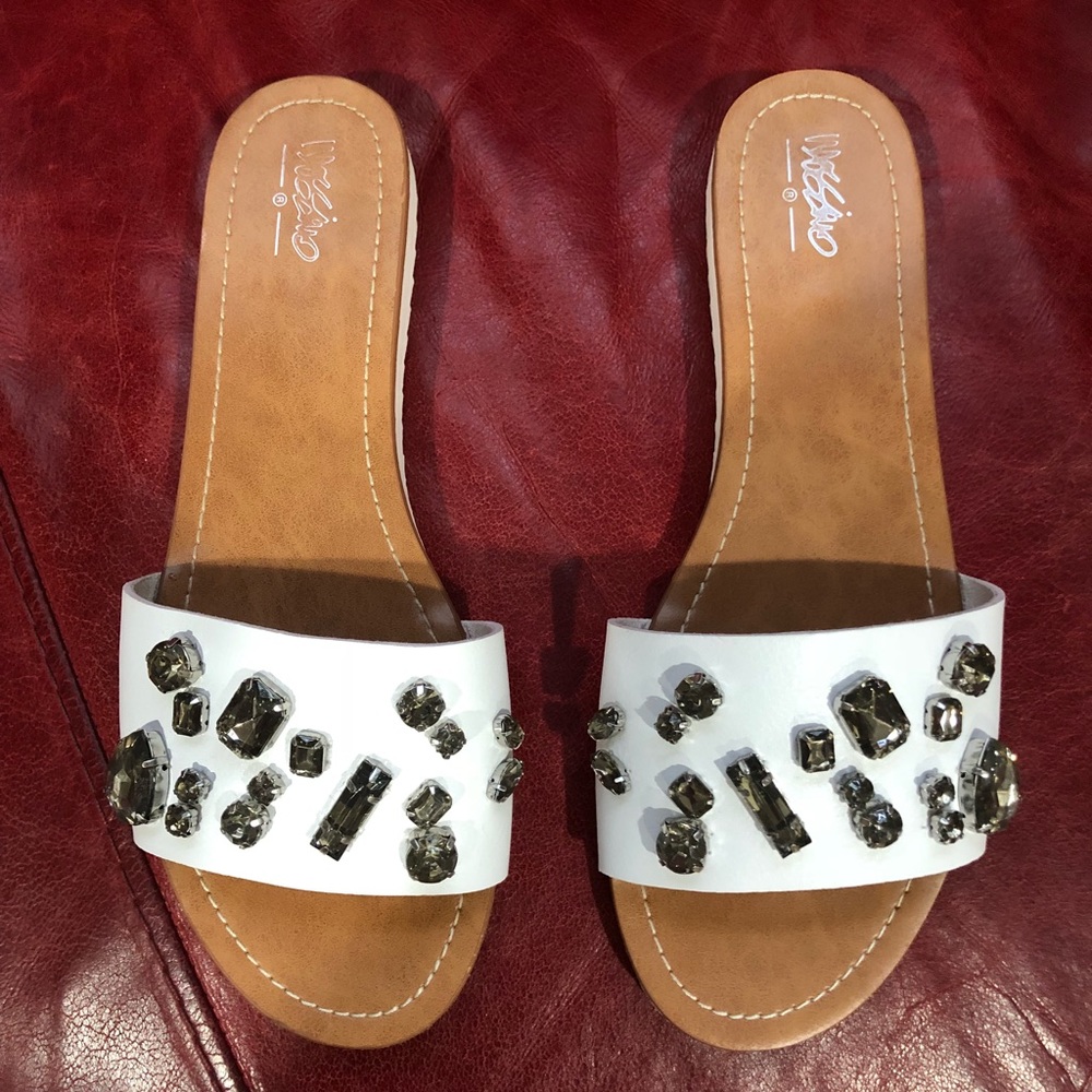 Adorable white slides with black gems.